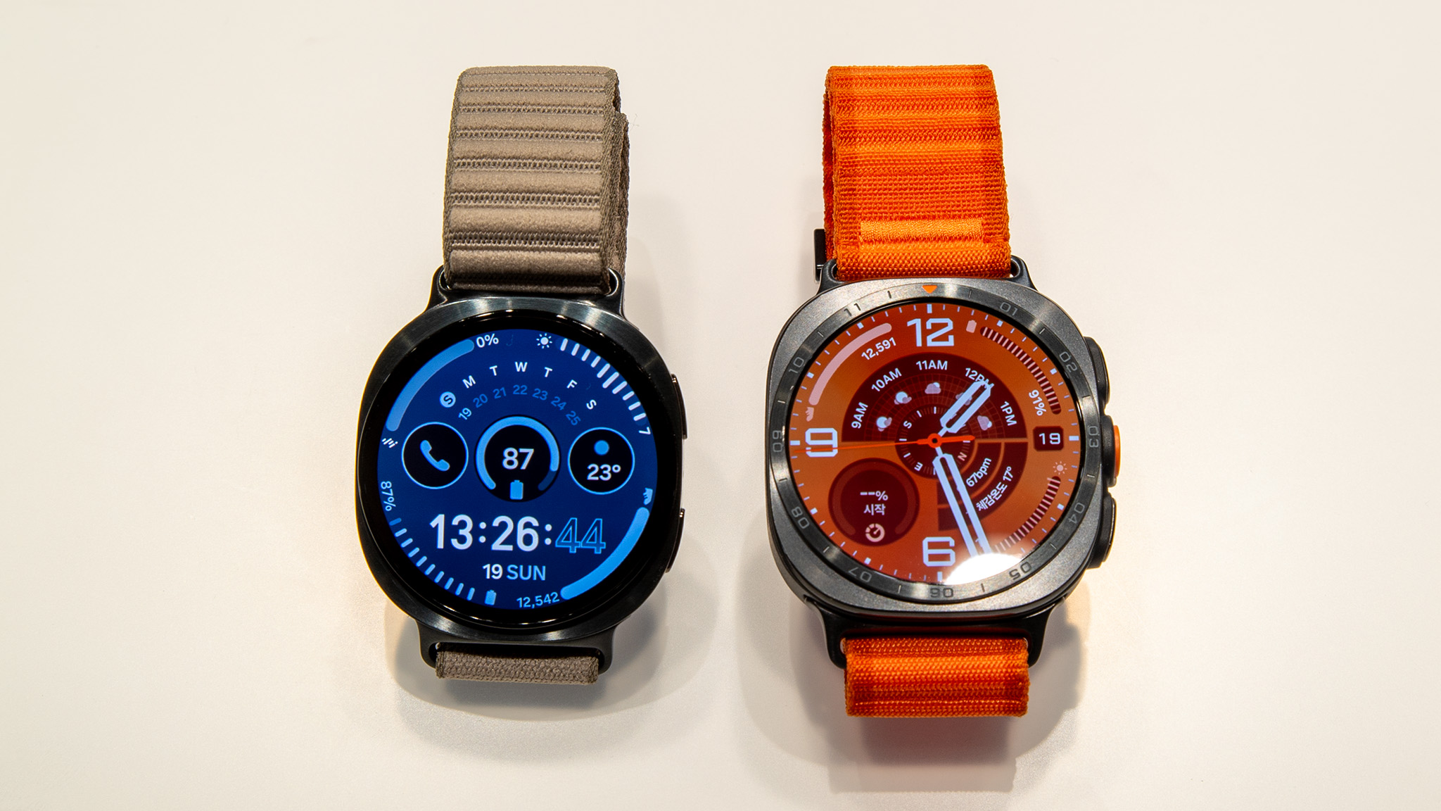 Galaxy Watch 9 and Galaxy Watch Ultra 2 side by side, showing the slimmer standard model beside the larger rugged Ultra model